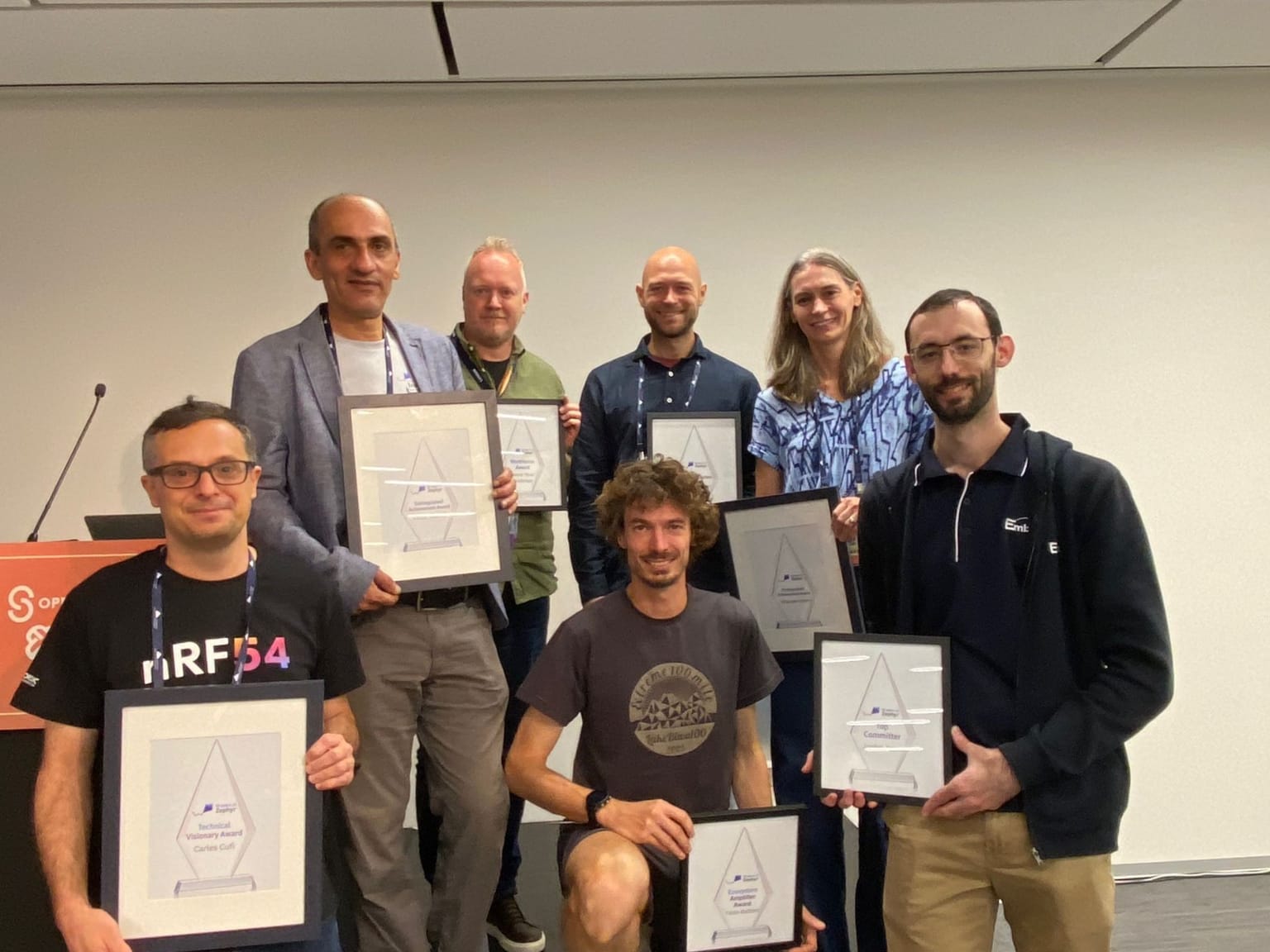 Jordan Yates with Zephyr award recipients, holding a Community Award
